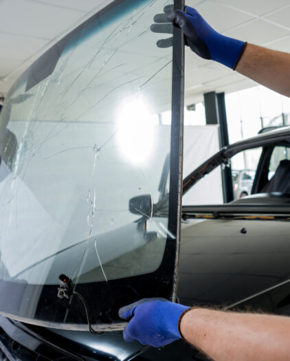 automobile special workers remove old windscreen windshield car auto service station garage